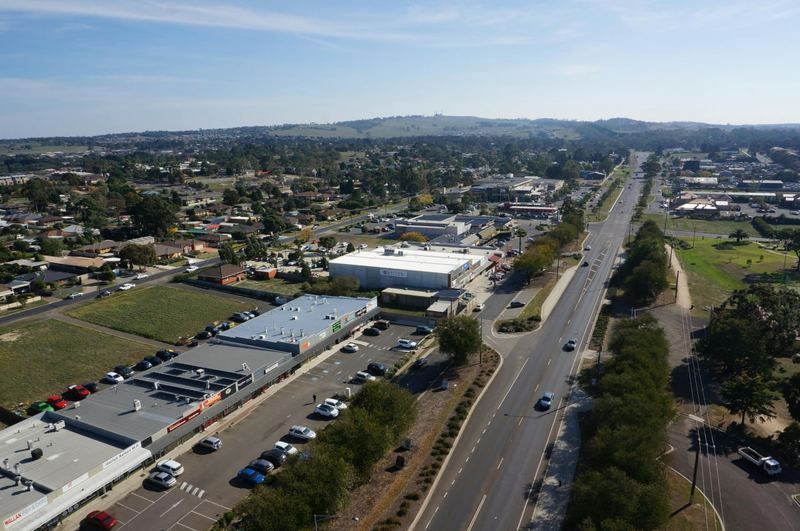 Aerial view of Wallan's High Street shopping strip with the surrounding hills in the distance